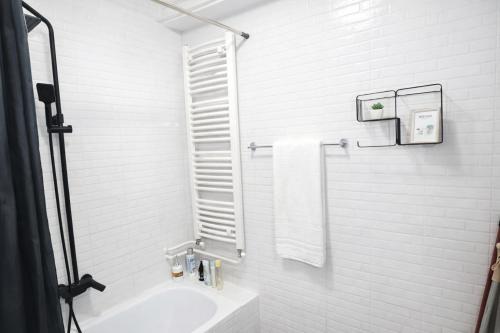 a white bathroom with a sink and a toilet at Apartman Lori M sa parkingom in Kraljevo