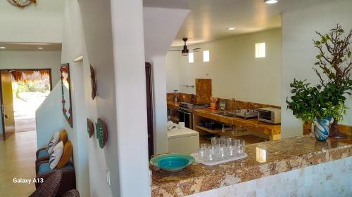 a kitchen with a counter with glasses on it at Villa Arkoi in Uaymitun