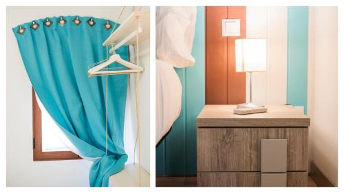 a bathroom with a blue curtain and a table at Sweet Home by Toledo AP in Toledo