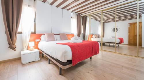 a bedroom with a large bed with a red blanket at Sweet Home by Toledo AP in Toledo