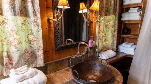 a bathroom with a sink and a mirror at Moon River Ranch in Satin