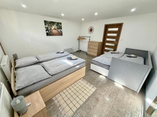 a bedroom with two beds and a staircase at U Pěti kohoutů in Liberec