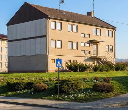 a large building with a sign in front of it at Kechnec - Seňa in Kehnec