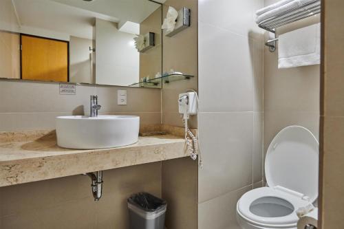 a bathroom with a sink and a toilet at Best Western Plus Gran Hotel Centro Historico in Guadalajara
