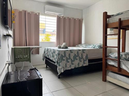 a bedroom with a bunk bed and a window at Casa da Esquina Pousada in Recife