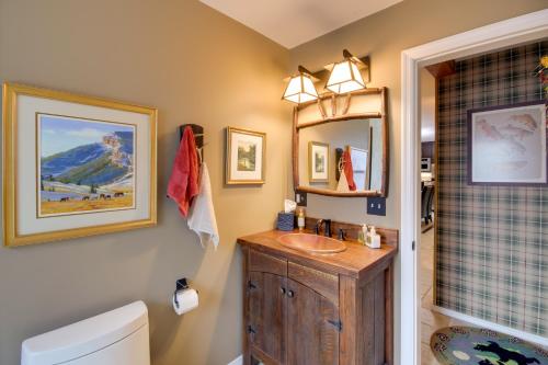 a bathroom with a sink and a toilet and a mirror at Boulder Dreams! Mtn-View Gem in McLeod in McLeod