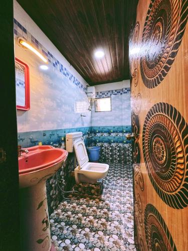 a bathroom with a toilet and a sink in it at Lonavala Golden Bird 3 bhk villa in Malavli