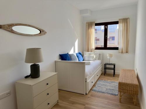 a bedroom with a bed with a mirror on the wall at Bel Air Surf Escape in El Cotillo