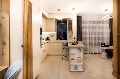 a kitchen with a sink and a table in a room at Atelier AS in Voluntari