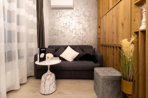 a living room with a couch and a table at Atelier AS in Voluntari