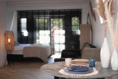 a living room with a table with plates on it at Loft 15 in Alkmaar