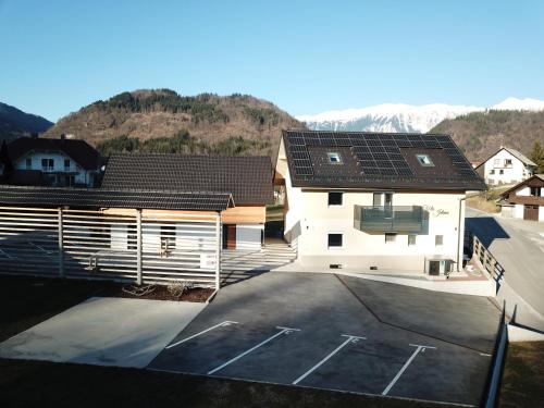a house with solar panels on the roof at Vila Jelena - modern spacious apartments near Vintgar Gorge & Bled in Zgornje Gorje