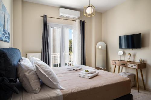 a bedroom with a bed with towels on it at Ioana Sea View in Corfu
