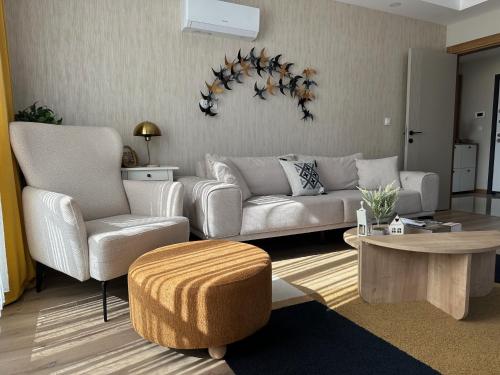a living room with a couch and two chairs and a table at Chic 2BR City Center Flat in Antalya