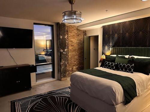 a bedroom with a large bed and a large window at Gilded Skyline, Walk Everywhere, 7th-Floor Views in Chattanooga