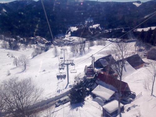 a ski lift going down a snow covered slope at Ski apartmány Spiežovec Donovaly in Donovaly