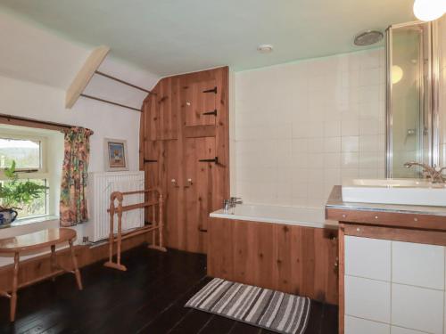 a bathroom with a tub and a sink at Plenteth in Truro