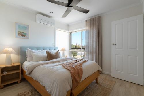 a bedroom with a bed with a ceiling fan at The Nook in Aldinga Beach
