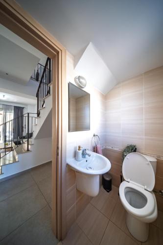 a bathroom with a toilet and a sink at Elia House In Kapparis in Paralimni