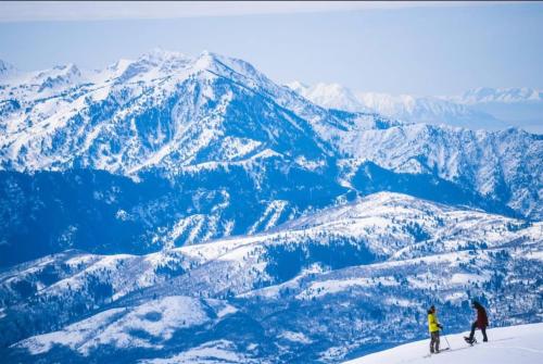 two people skiing on top of a snowy mountain at Eden Mtn Retreat MH207 Near Powder Mtn Hot Tub in Eden