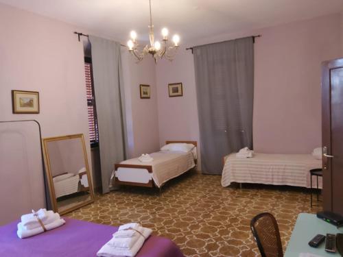 a hotel room with two beds and a mirror at Villa Caterina in Fiuggi