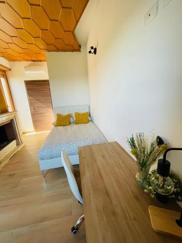 a bedroom with a bed and a wooden table at Bencivenga Terrace in Rome