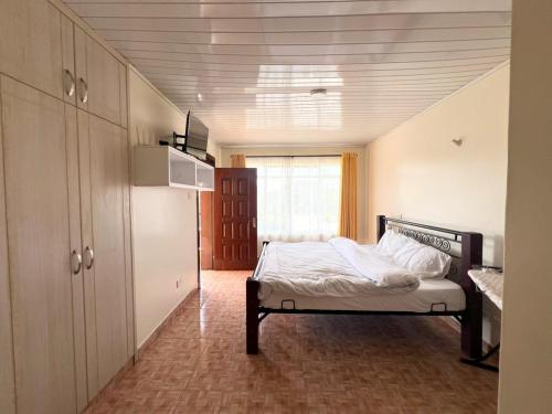 a bedroom with a bed in the middle of a room at Crystal Luxury Palace in Nairobi