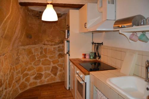 a kitchen with a sink and a counter top at El Encantodemora in Mora de Rubielos
