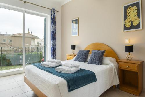 a bedroom with a bed and a large window at B76 - Piedade Apartment in Lagos in Lagos