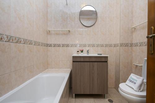 a bathroom with a tub and a toilet and a sink at B76 - Piedade Apartment in Lagos in Lagos