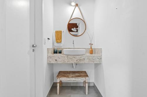 a bathroom with a sink and a mirror on the wall at A CASA DA PRAIA DO FORTE in Praia do Forte