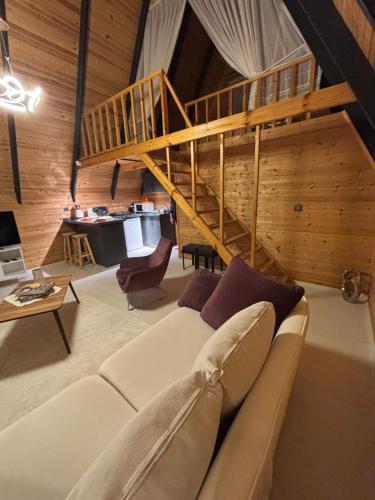a living room with a couch and a staircase at Atlasluxuryhome mor in Samsun