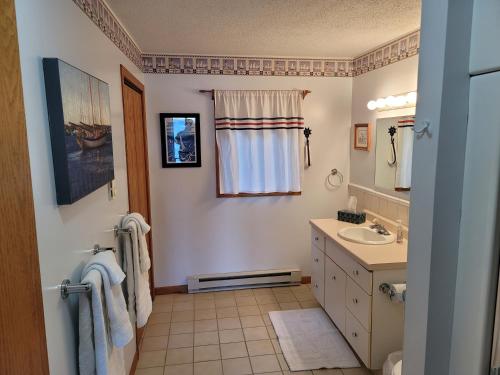 a bathroom with a sink and a mirror at Bayfield Island View Lodging, Bayfield, WI in Bayfield