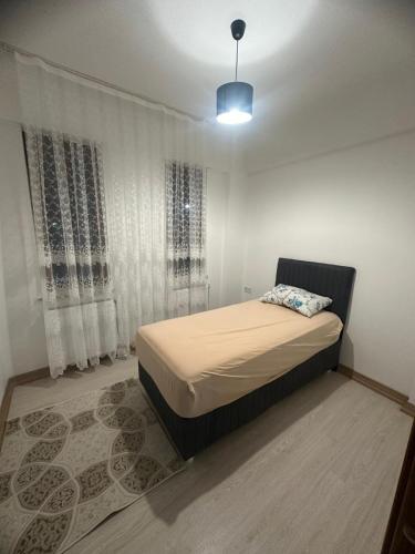 a small bedroom with a bed and a window at Roz Family Mansion 2 in Diyarbakır