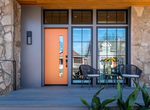 an orange door on a patio with a table and chairs at Holy Grail in Atlanta