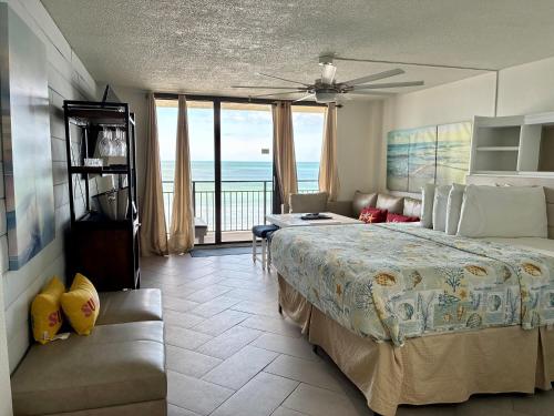 a bedroom with a bed and a view of the ocean at Daytona Beach Hawaiian Inn in Daytona Beach