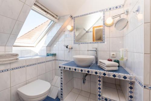 a bathroom with a sink and a toilet at Hotel Villa Sonneck-Adults Only in Böhl