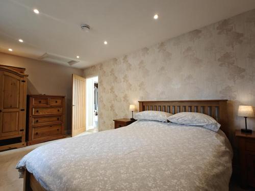 a bedroom with a large bed with two pillows at 1 Bed in Langmere oc-m33974 in Dickleburgh