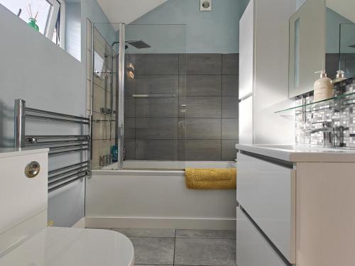 a bathroom with a shower and a toilet and a tub at 1 Bed in Langmere oc-m33974 in Dickleburgh
