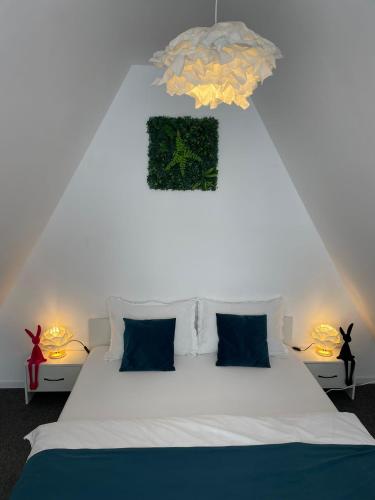 a bedroom with a white bed and two lamps at LaKadisa pe Lac in Porumbacu de Jos