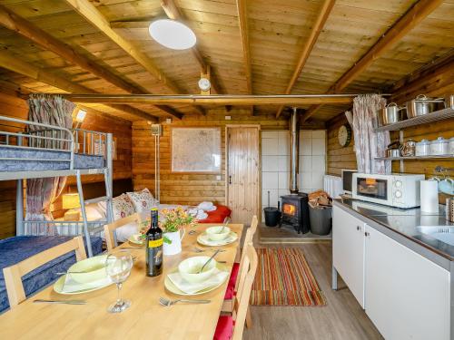 a kitchen and dining room with a table in a cabin at Starling Lodge - Uk31071 in Westward