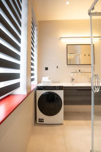 a washing machine in a bathroom with a sink at Brunova Vila in Plavy