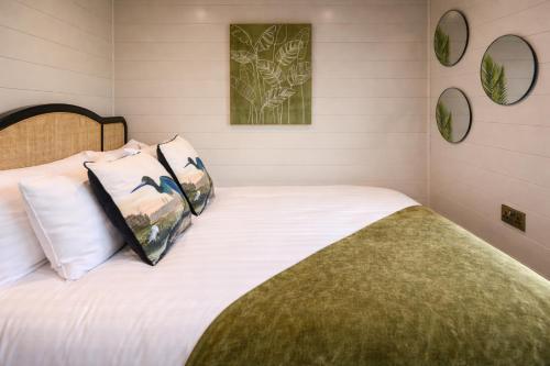a bedroom with a bed with white sheets and pillows at Staining Luxury Lodges in Poulton le Fylde