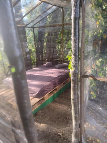 a bed in a tent in the woods at Domki bungalowe nr 8 in Stosrow