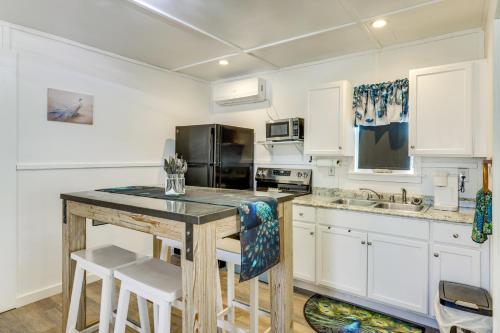 a kitchen with white cabinets and a wooden table at Pet-Friendly Canyon Lake Studio Fish, Boat, Relax in Canyon Lake