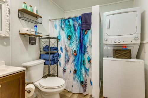 a bathroom with a toilet and a shower curtain at Pet-Friendly Canyon Lake Studio Fish, Boat, Relax in Canyon Lake