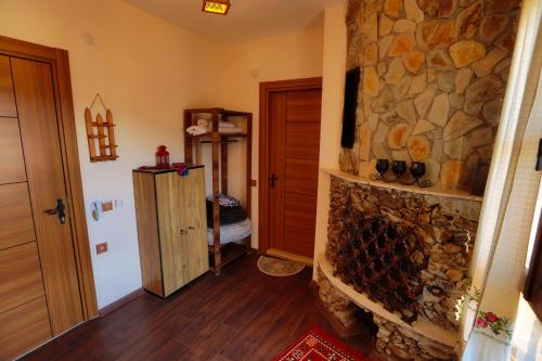 a living room with a stone fireplace in a house at İkiz Konaklar in Selçuk