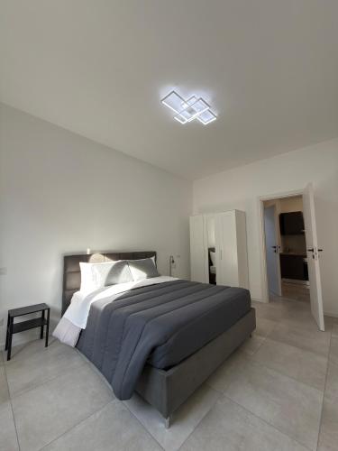 a white bedroom with a large bed in a room at Soul house in Corsico