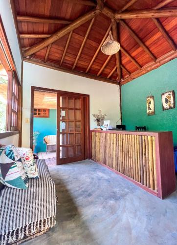 a living room with a bed and a wooden ceiling at Flat Barra in Barra Grande
