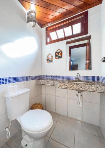 a bathroom with a toilet and a sink at Flat Barra in Barra Grande